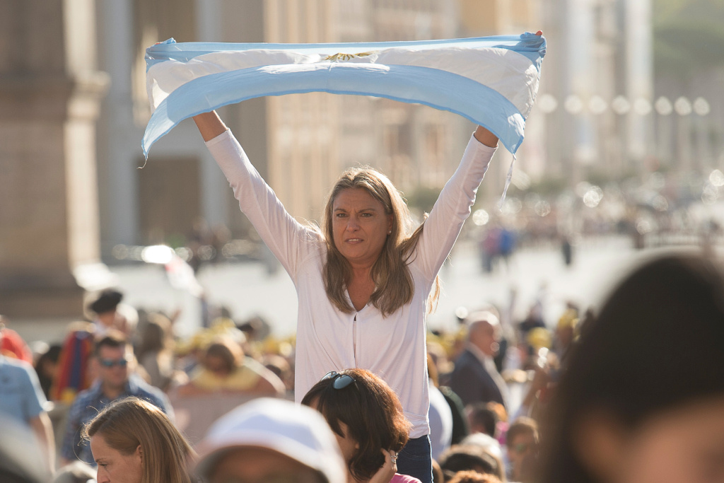 Eine Frau hält eine argentinische Fahne in die Höhe während der wöchentlichen Generalaudienz.           Foto: KNA