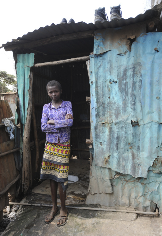 Ein Mädchen steht vor einem Plumpsklo in einem Slum in Nairobi (Kenia). (Foto: KNA)